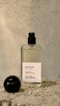Echo Notes Cherry Oud perfume bottle framed by juicy red cherries, dark rose petals, agarwood, and supple leather.