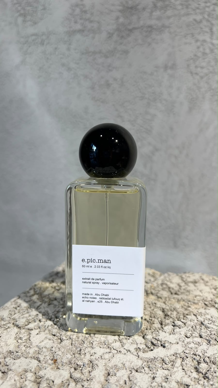 Echo Notes Epic Man perfume bottle surrounded by pink peppercorns, saffron threads, olibanum tears, and dark leather.