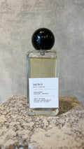 Echo Notes Halfeti perfume bottle framed by vibrant saffron, deep Bulgarian rose petals, and dark agarwood oud.