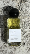 Echo Notes Impadia perfume bottle surrounded by fresh juicy pears, blooming roses, and warm vanilla absolute.