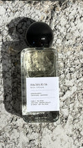 Echo Notes Matsukita perfume bottle framed by fresh bergamot, aromatic mate leaves, and rich guaiac wood.