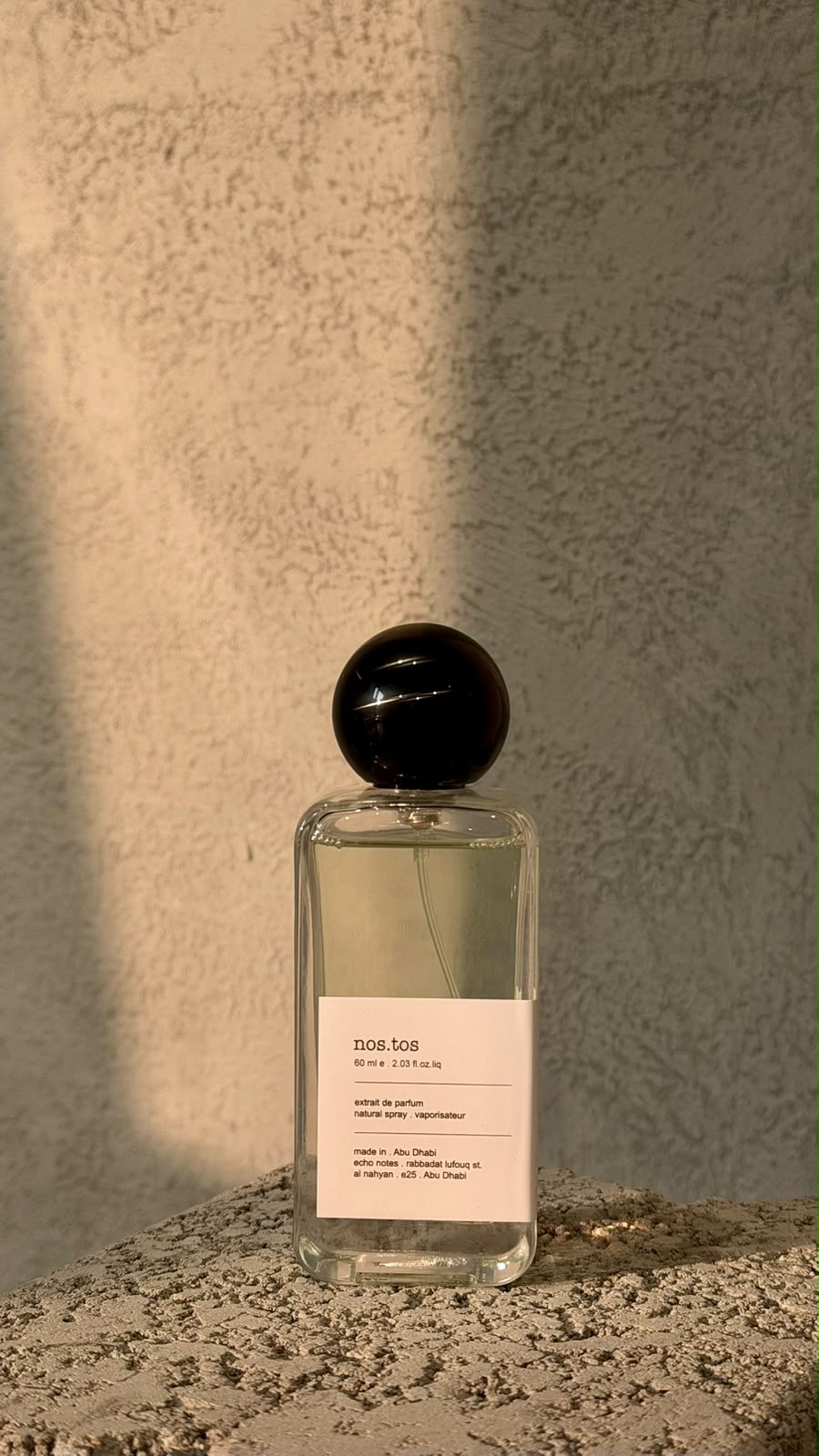 Echo Notes Nostos perfume bottle framed by warm saffron strands, rich incense smoke, Turkish rose, and dark oud wood.
