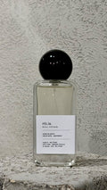Echo Notes Eau Rihla Eau de Parfum bottle surrounded by raspberry, spicy saffron, and smooth leather accents.