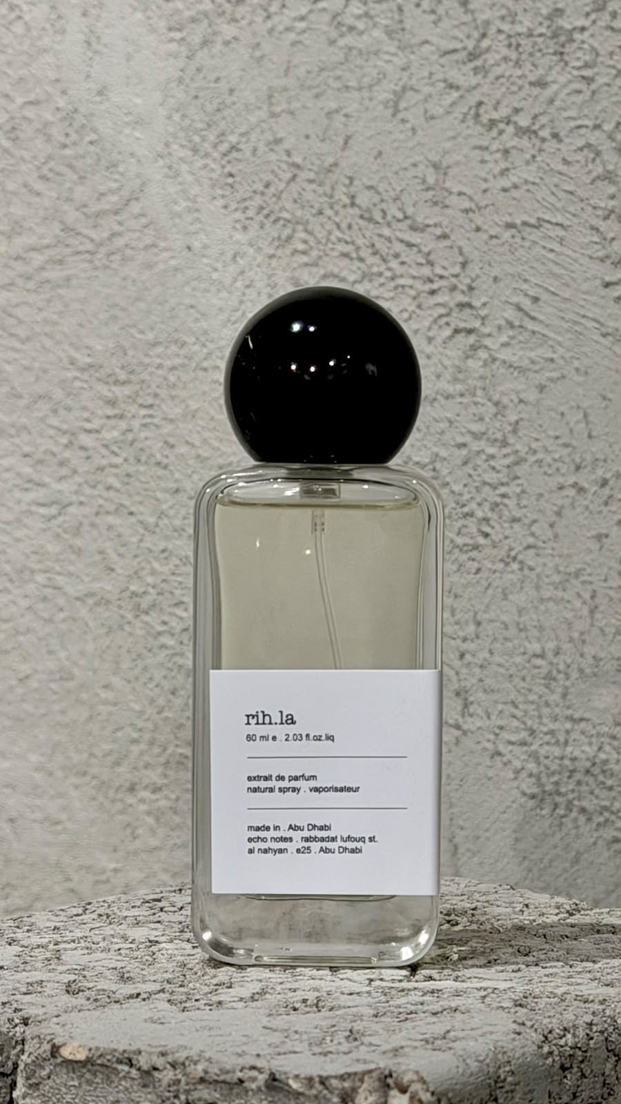 Echo Notes Eau Rihla Eau de Parfum bottle surrounded by raspberry, spicy saffron, and smooth leather accents.