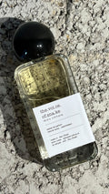 Echo Notes The Voice Of The Snake perfume bottle surrounded by rich agarwood, dried saffron threads, and patchouli leaves.