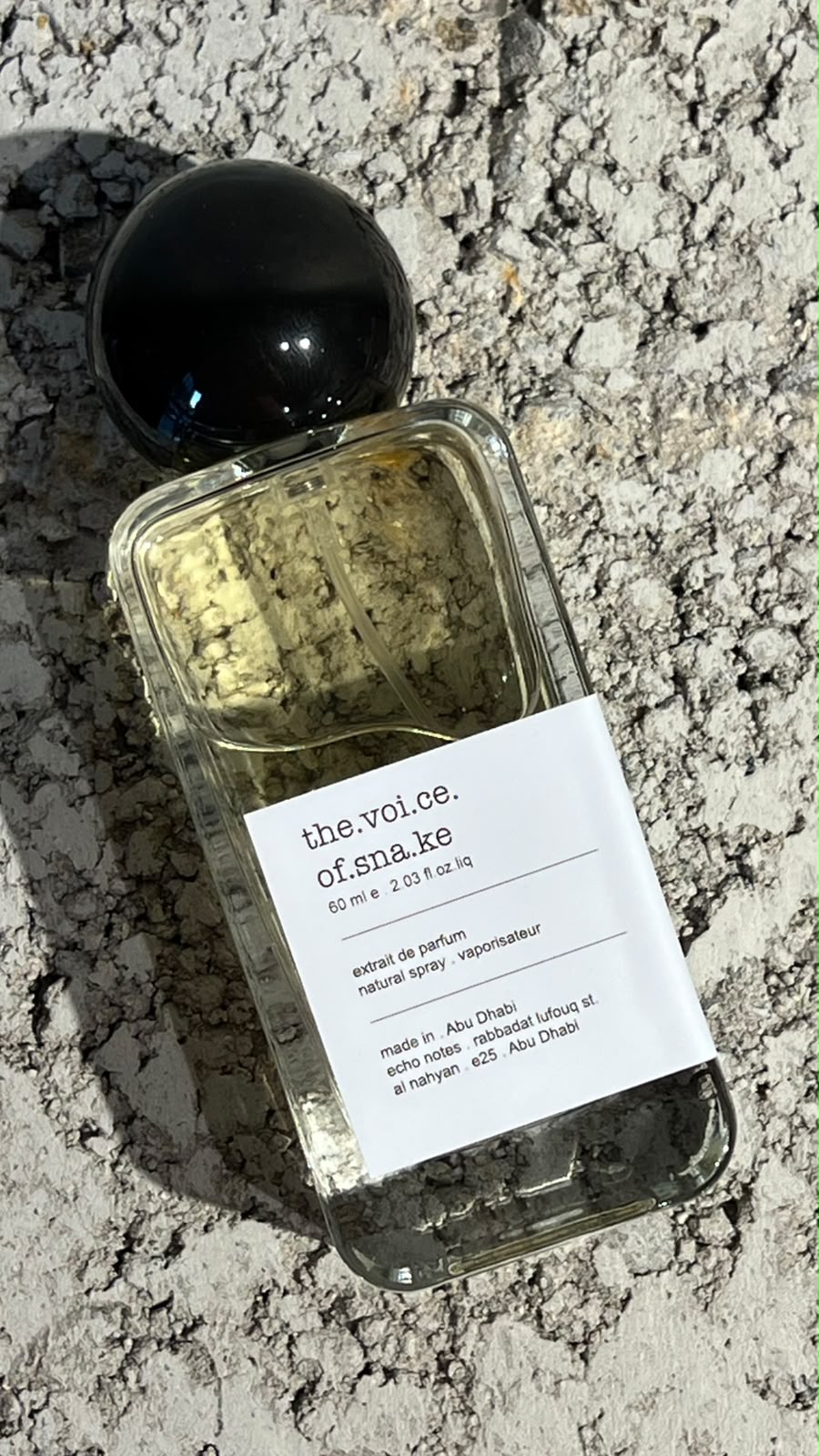 Echo Notes The Voice Of The Snake perfume bottle surrounded by rich agarwood, dried saffron threads, and patchouli leaves.