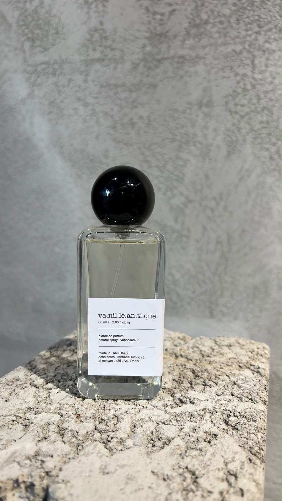 Echo Notes Vanille Antique perfume bottle surrounded by whole vanilla beans, golden amber chunks, and dark dried plums.